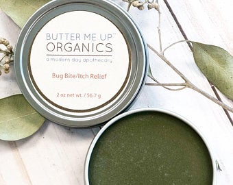 Butter Me Up Organics product with green paste and leaves on a light background