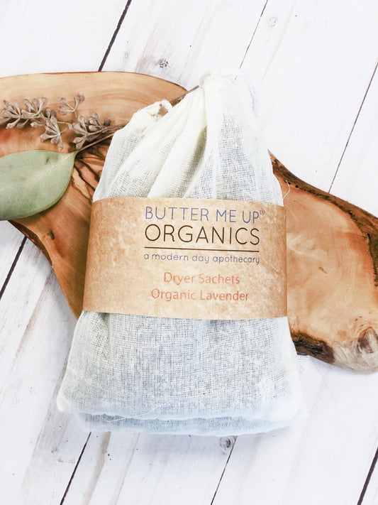 Butter Me Up Organics dryer sachet on a wooden surface with a label
