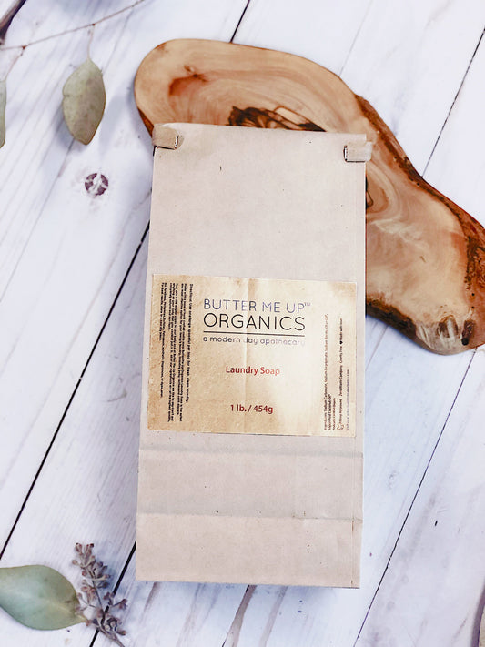 Butter Me Up Organics laundry soap package on a wooden surface