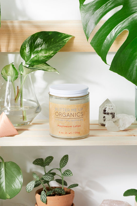 Jar of 'Supplement Organics' on a shelf with plants and crystals in the background