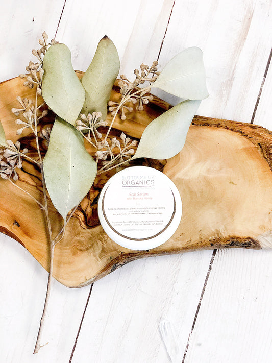 Scar Serum container on a wooden tray with florals