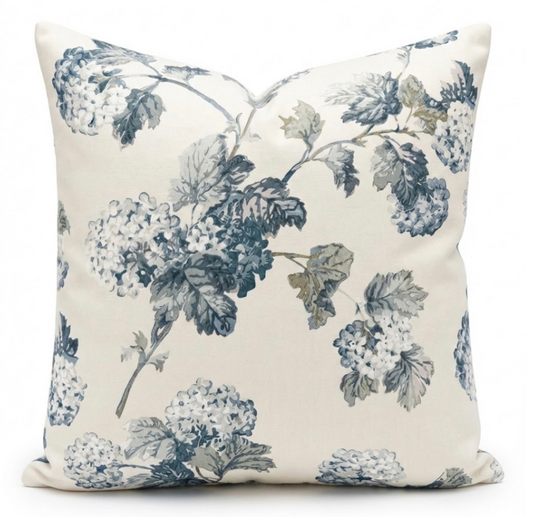 Decorative pillow with blue floral pattern on a white background