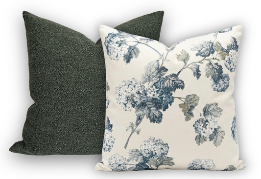 Floral-patterned pillow and a plain dark gray pillow on a light background