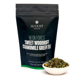 August tea package with a bowl of green tea leaves on a white background