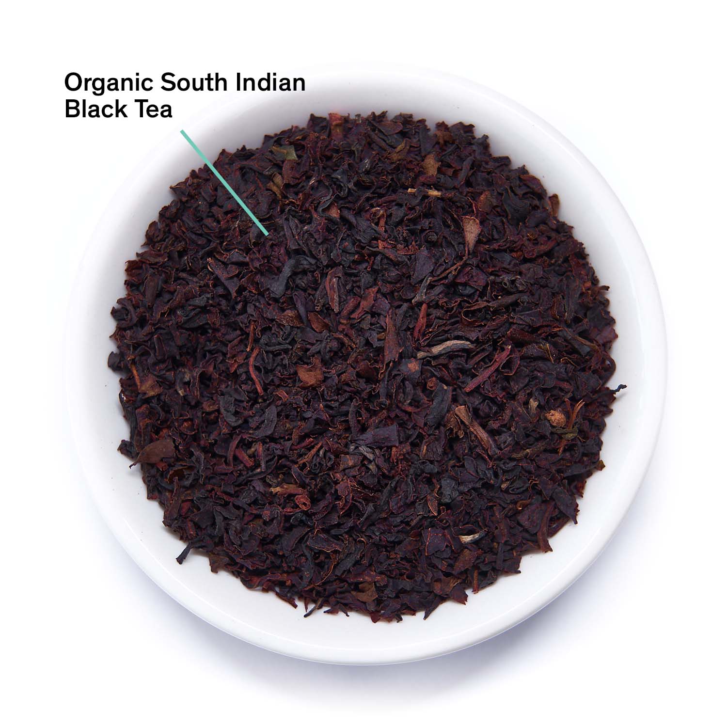 Organic South Indian Black Tea leaves in a white bowl on a white background