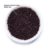 Organic South Indian Black Tea leaves in a white bowl on a white background