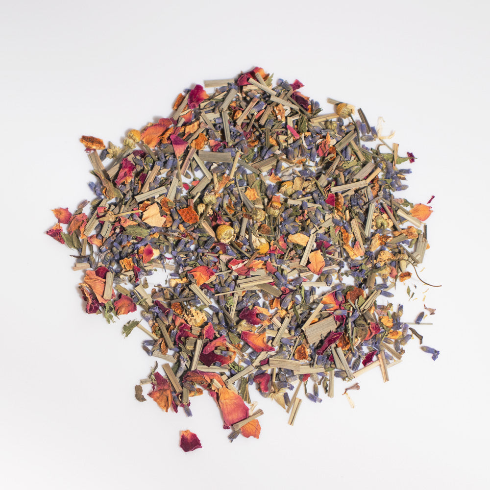 Assorted dried herbs and flowers on a white background