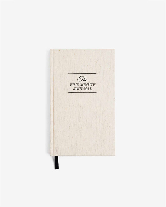 Beige journal with 'The Five Minute Journal' text on a white background