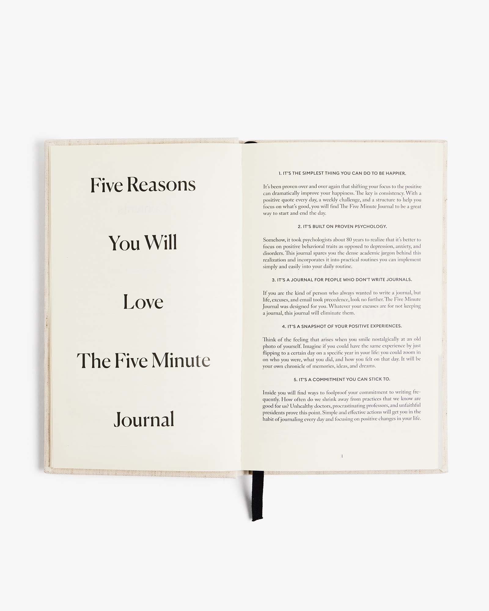 Open book with text about 'The Five Minute Journal' on a white background