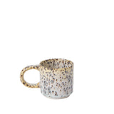 Speckled ceramic mug on a white background