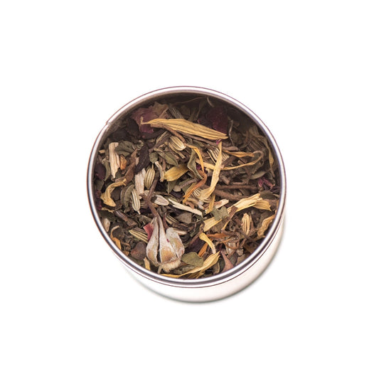 Tea leaves in a metal tin on a white background