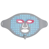 LED face mask with blue and pink lights on a white background