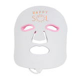 White face mask with pink eye areas and 'Happy Sol' branding on a white background
