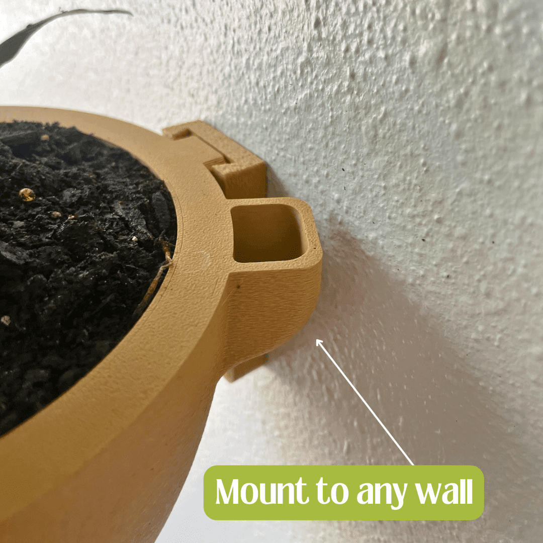 Brown pot with a plant mounted on a white wall with text 'Mount to any wall'.