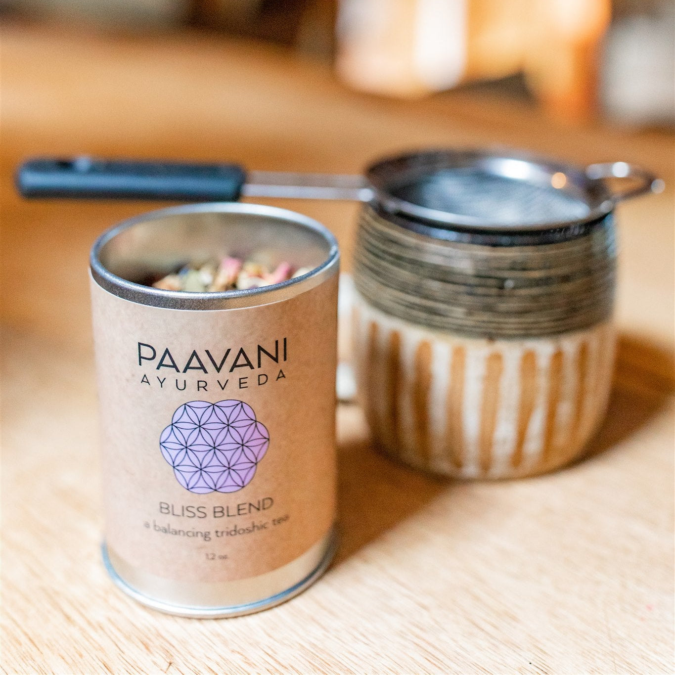 Paavani Ayurveda Bliss Blend container on a wooden surface with a blurred background