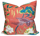 Decorative pillow with floral and bird pattern on a red background