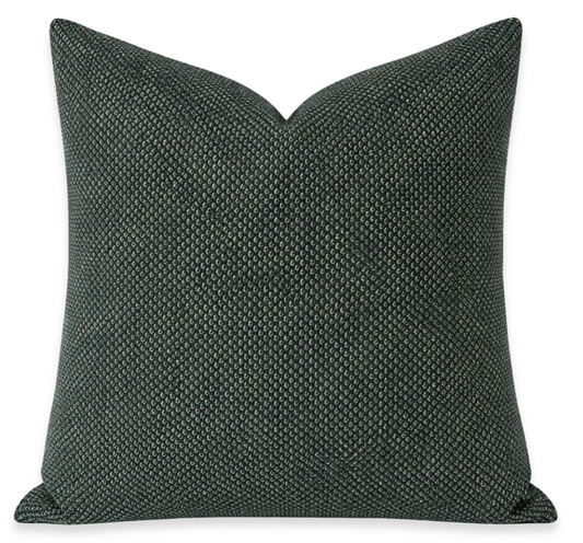 Textured dark green pillow on a white background