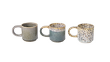 Three ceramic mugs with speckled patterns on a white background
