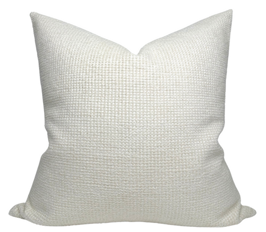 Textured white pillow on a white background