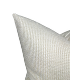 Close-up of a textured white pillow on a white background