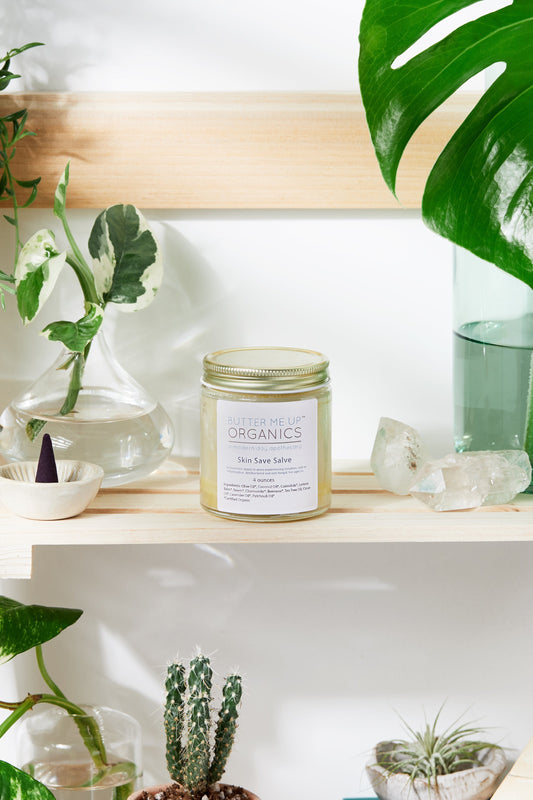 Jar of 'Organics' on a shelf with plants and crystals