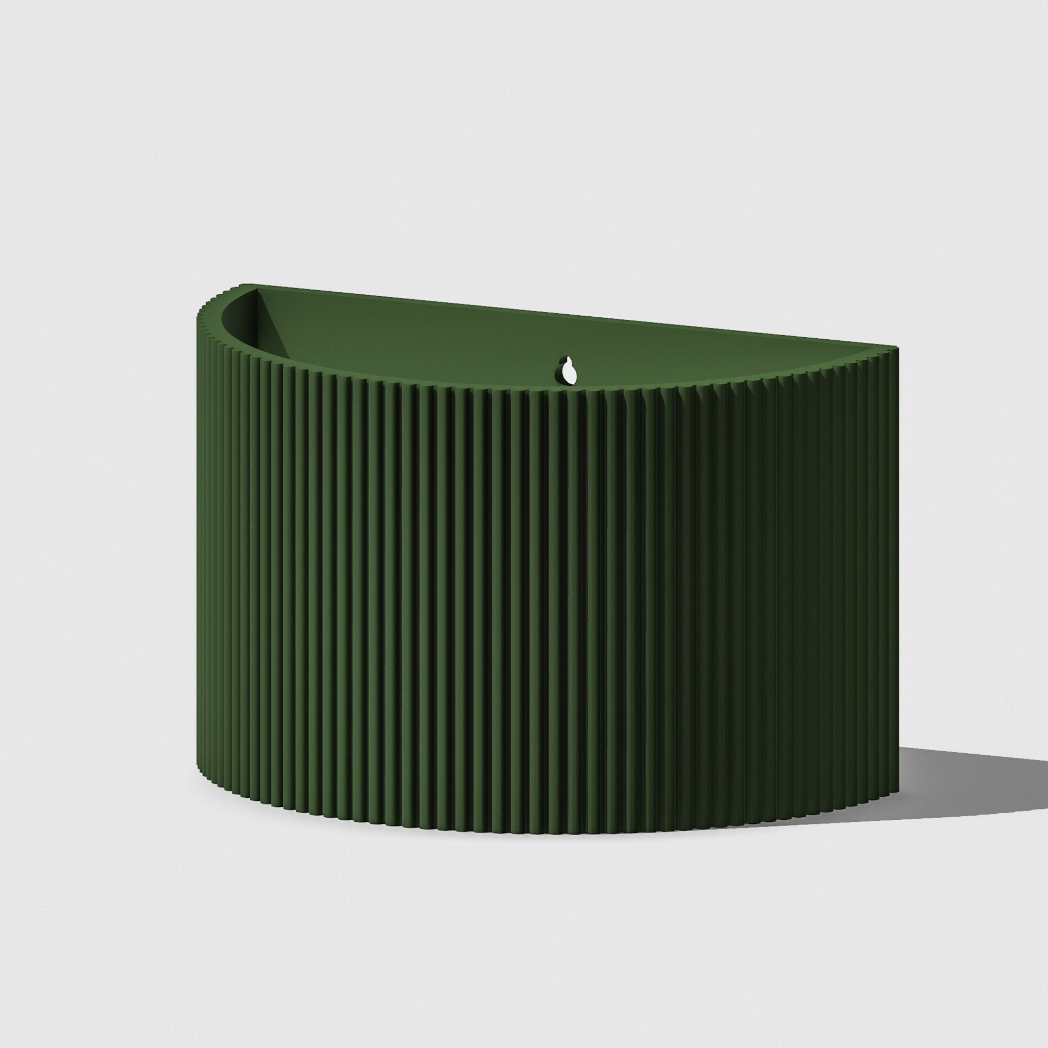 Green ribbed candle on a light gray background