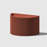 Brown ribbed planter on a light gray background