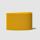 Yellow ribbed planter on a light gray background